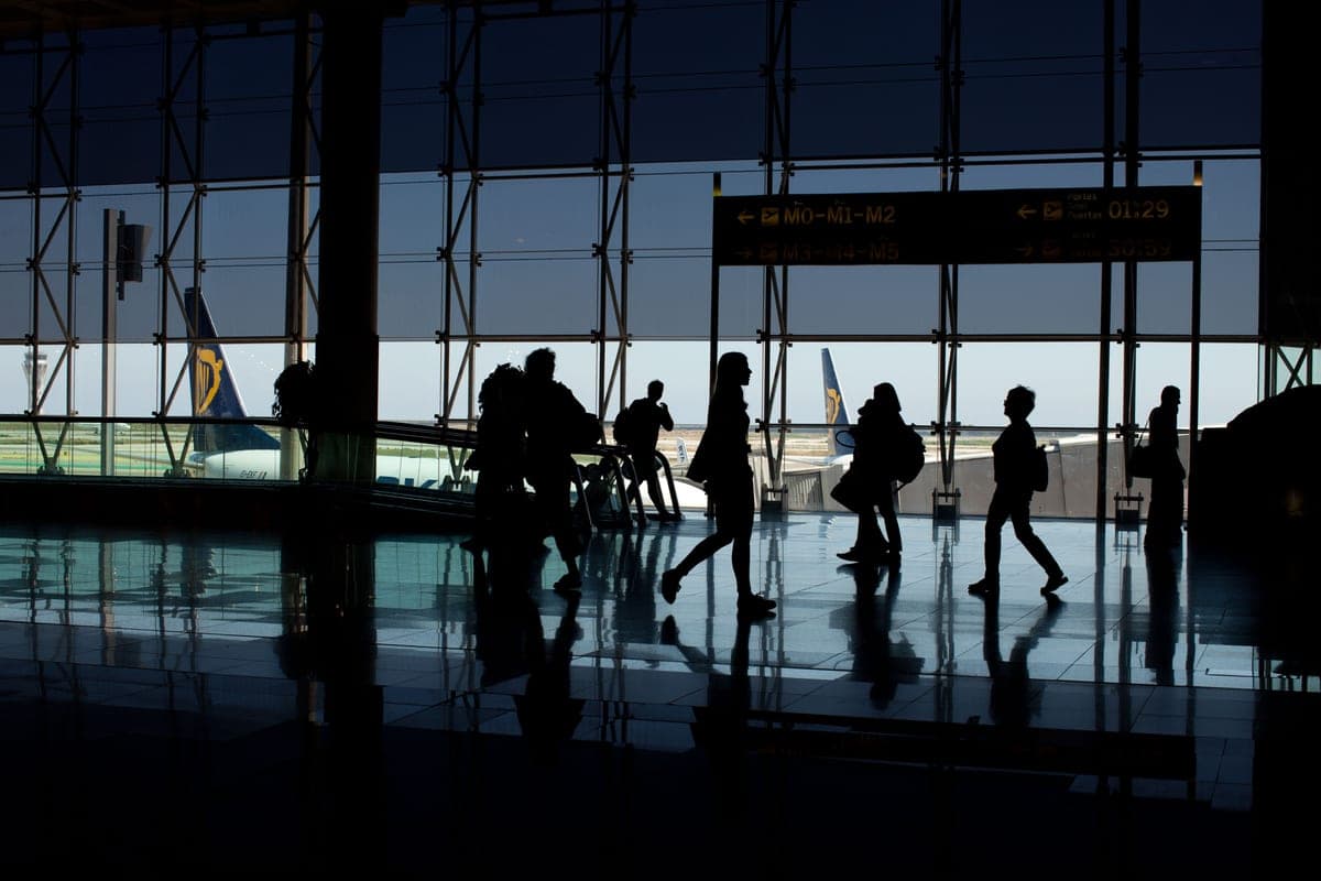 Travelers with luggage in an airport terminal