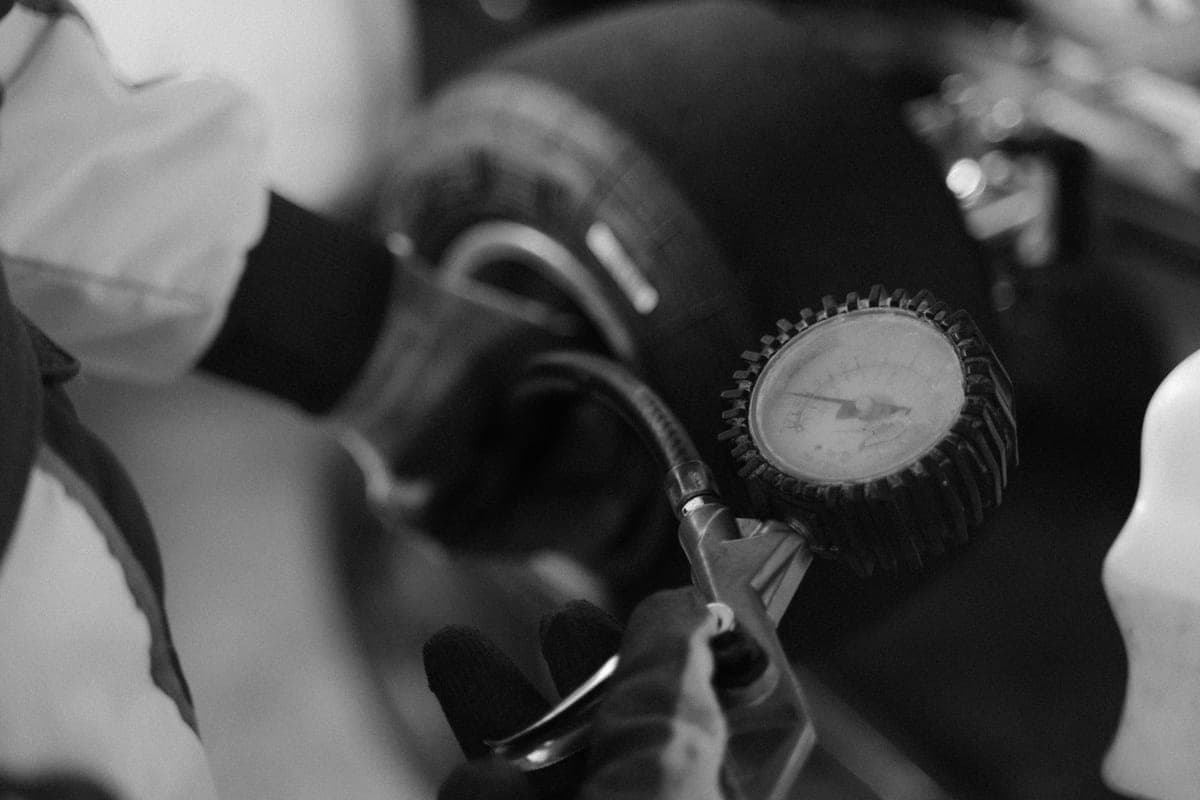 A pressure gauge being used to check a tire